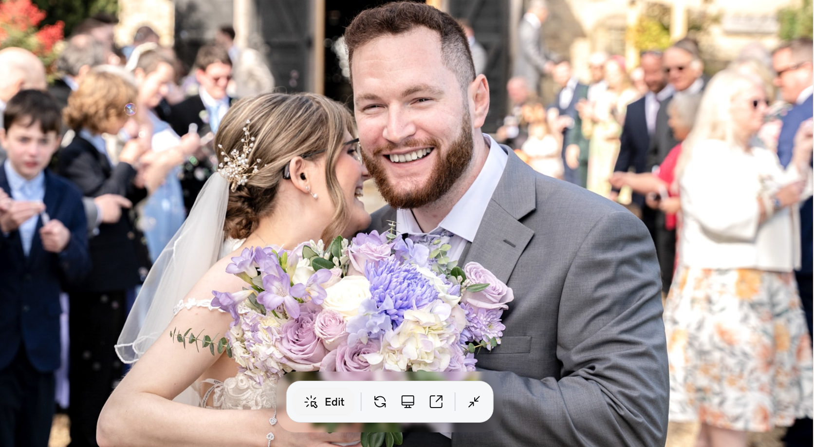 Bride and groom smiling joyfully with purple bouquet outside church at Notley Tythe Barn wedding