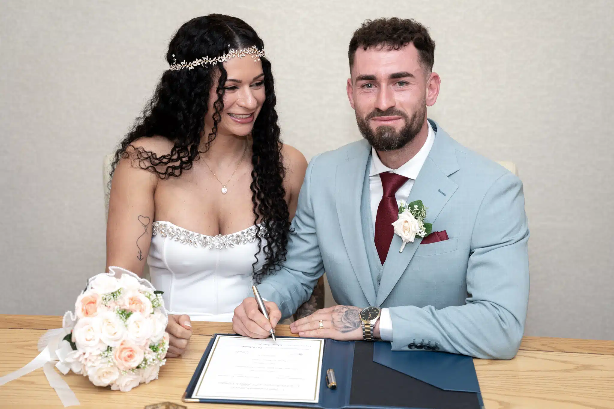 Bride and grrom signing registrar 