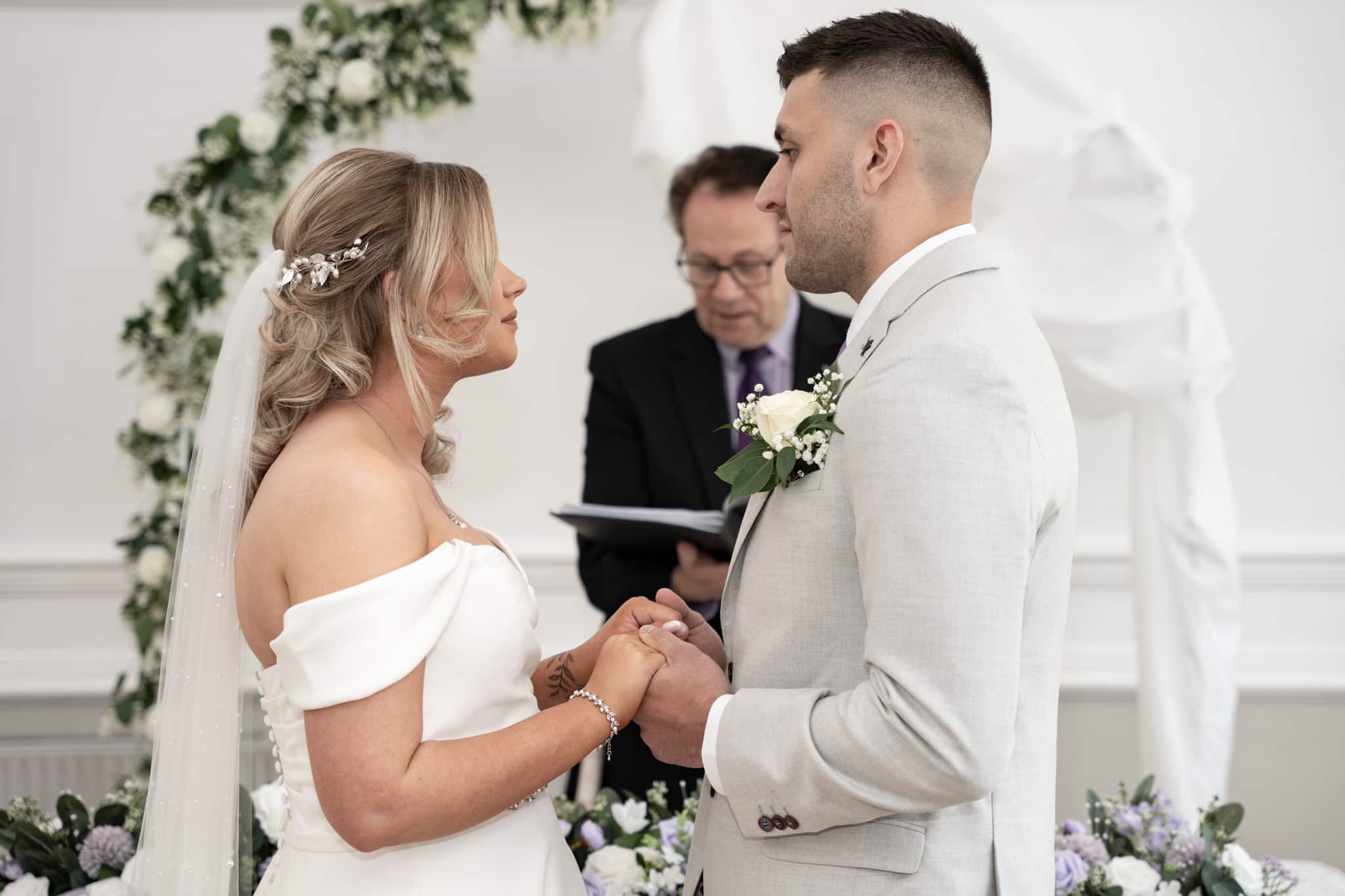 bride and groom holding hands at shenley cricket club