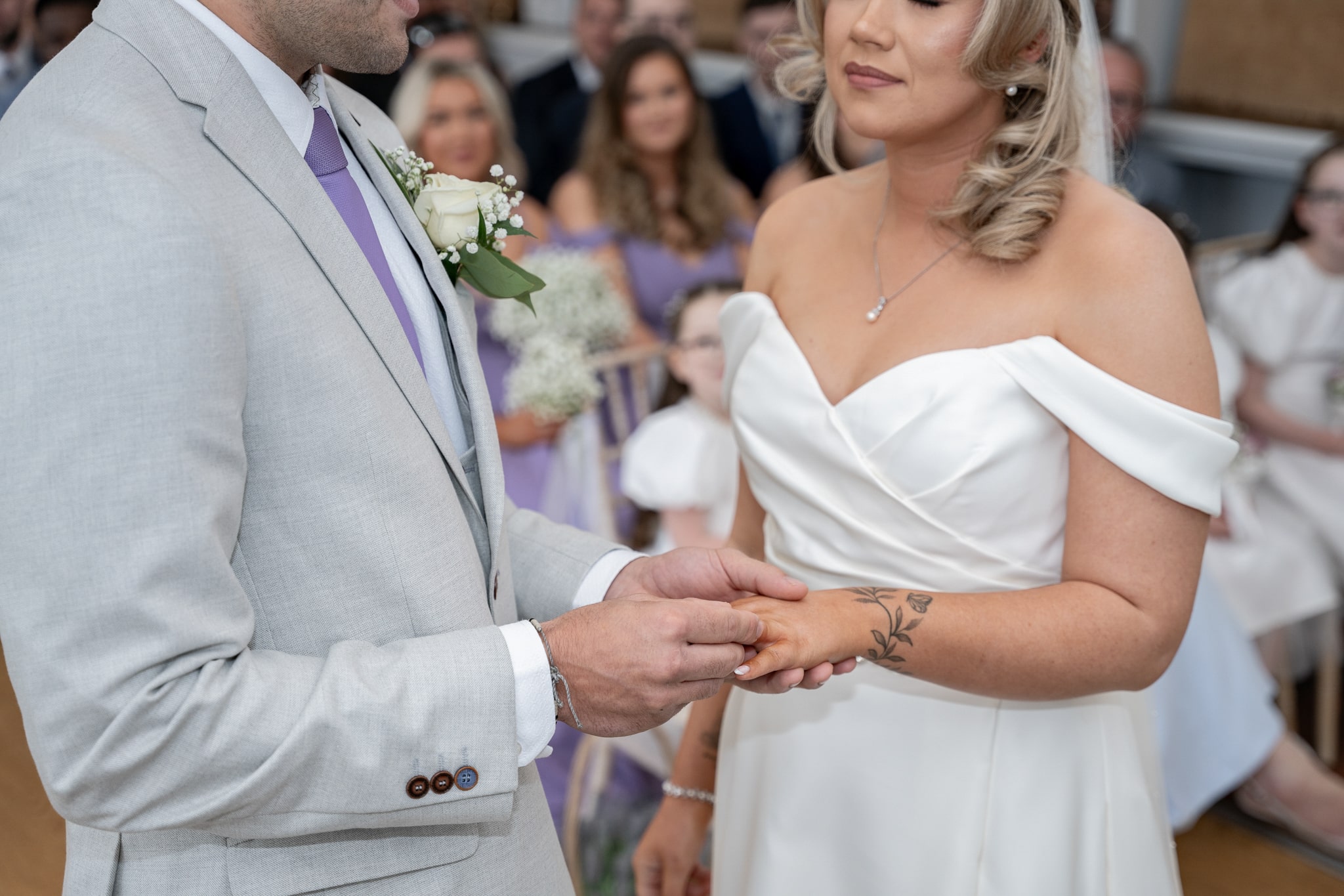 bride and groom exchanging rings