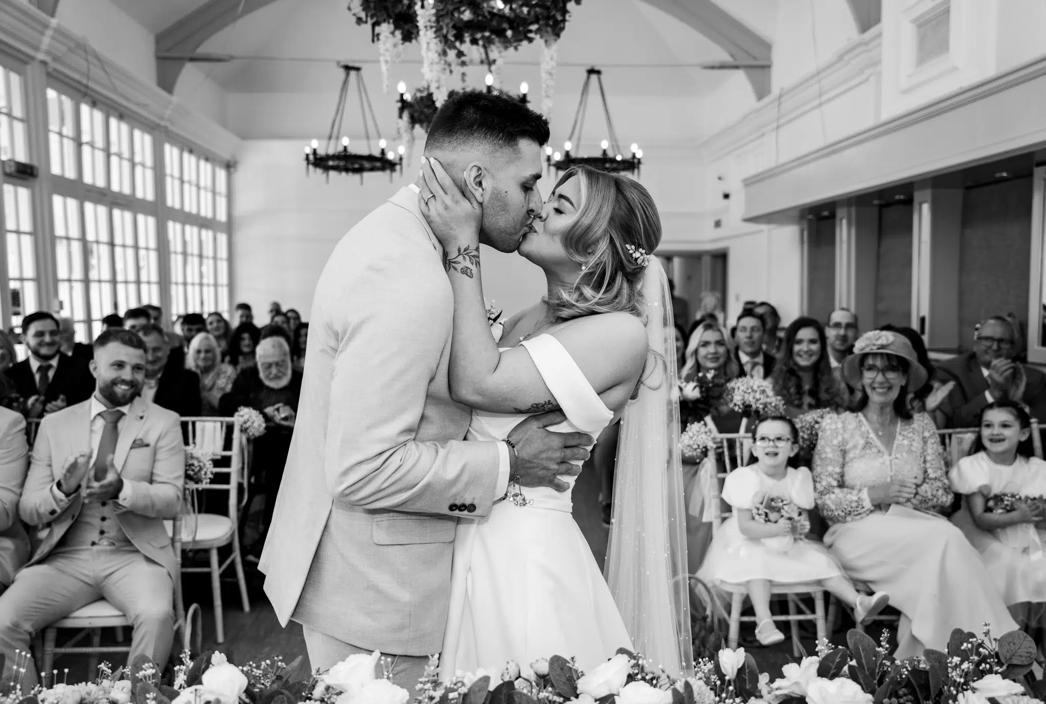 bride and groom kissing in black and white
