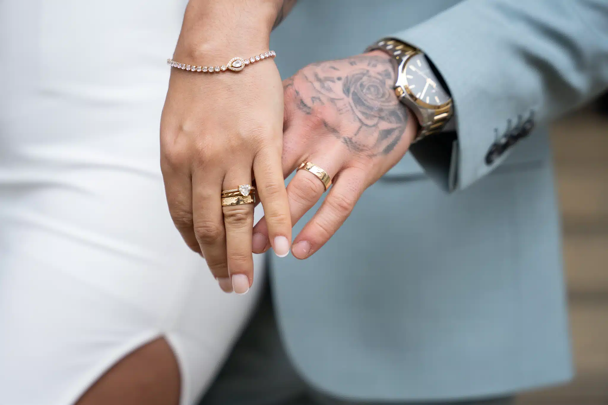 wedding rings on bride and grroms hands. Close up