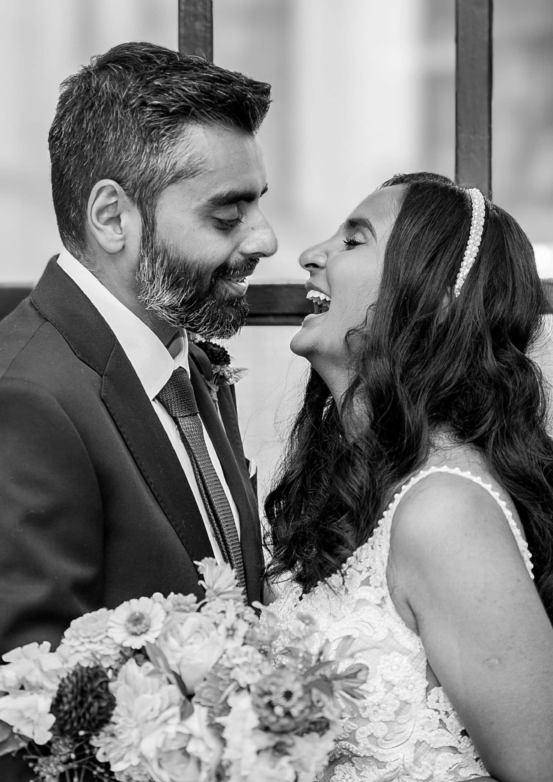 Bride and groom laughing black and white image