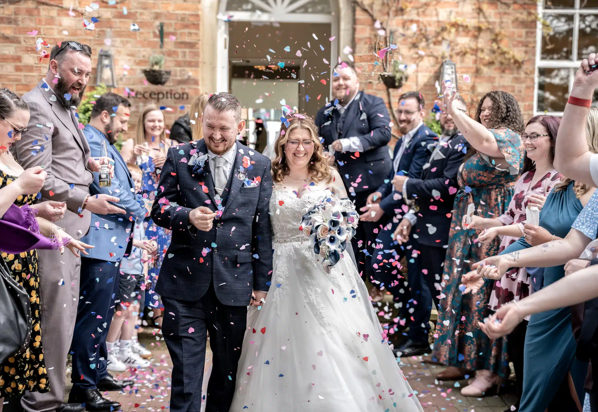 bride and groom under a shower of confetti