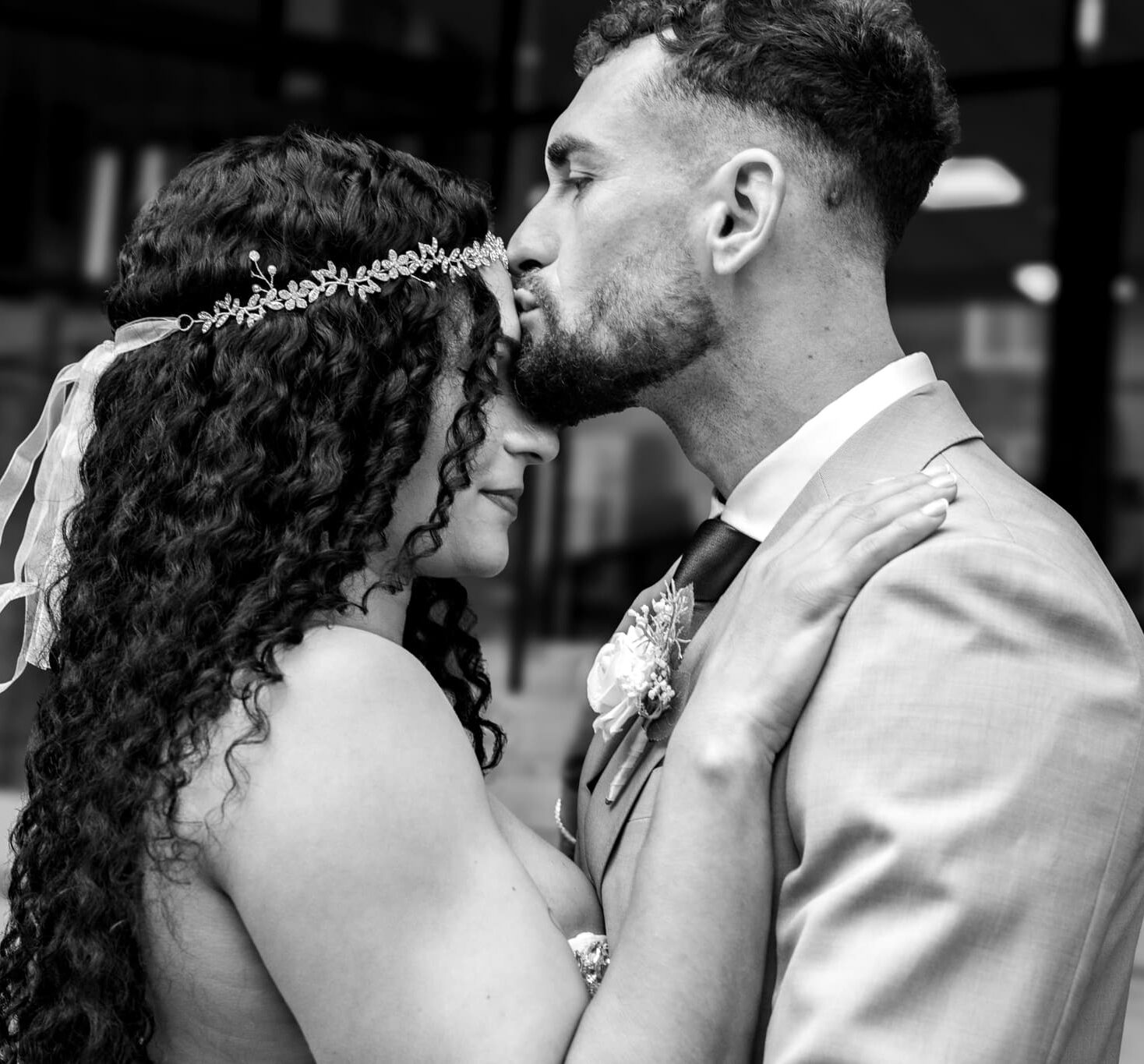 groom kissing bride on the forehead
