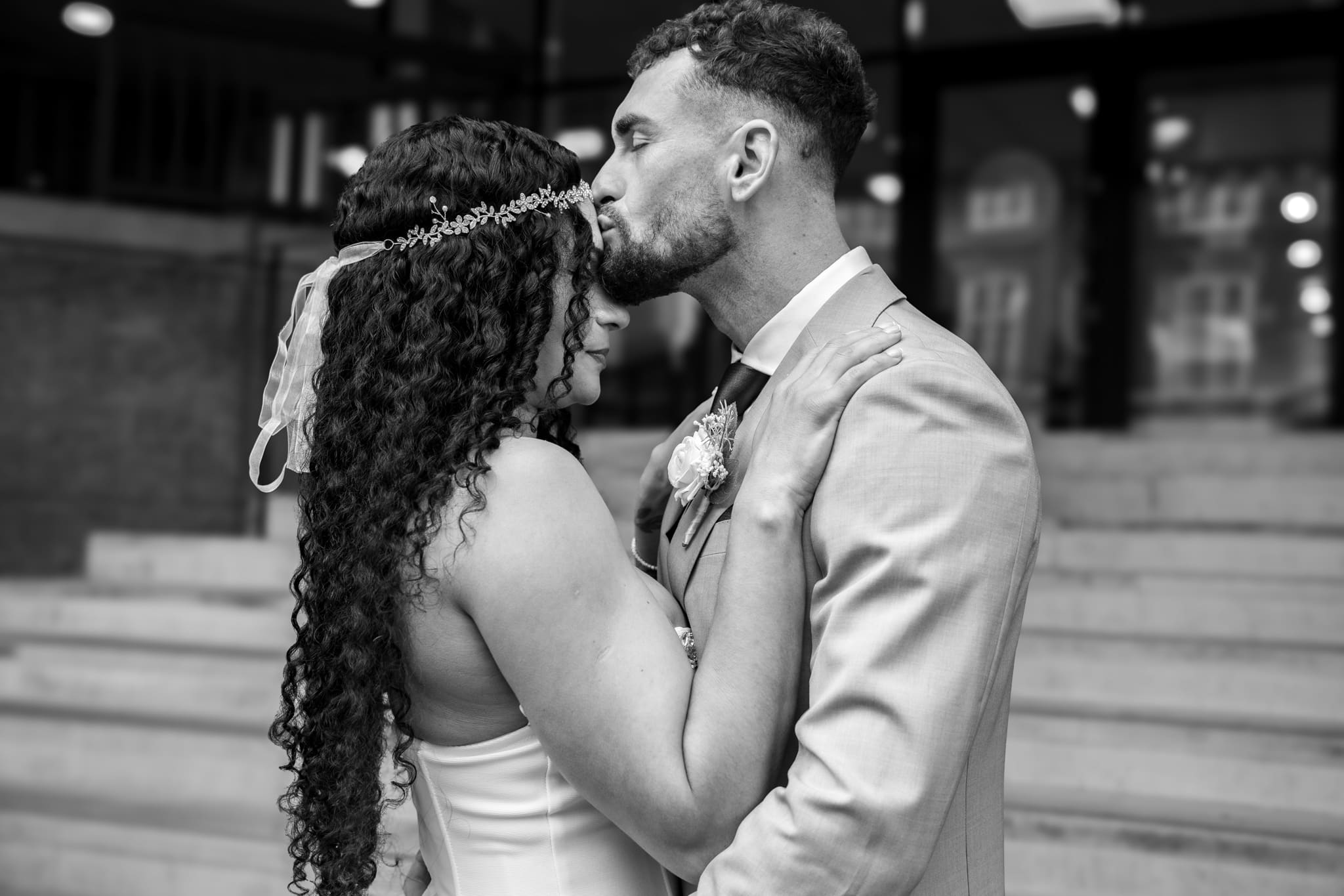 groom hissing brides head black and white image