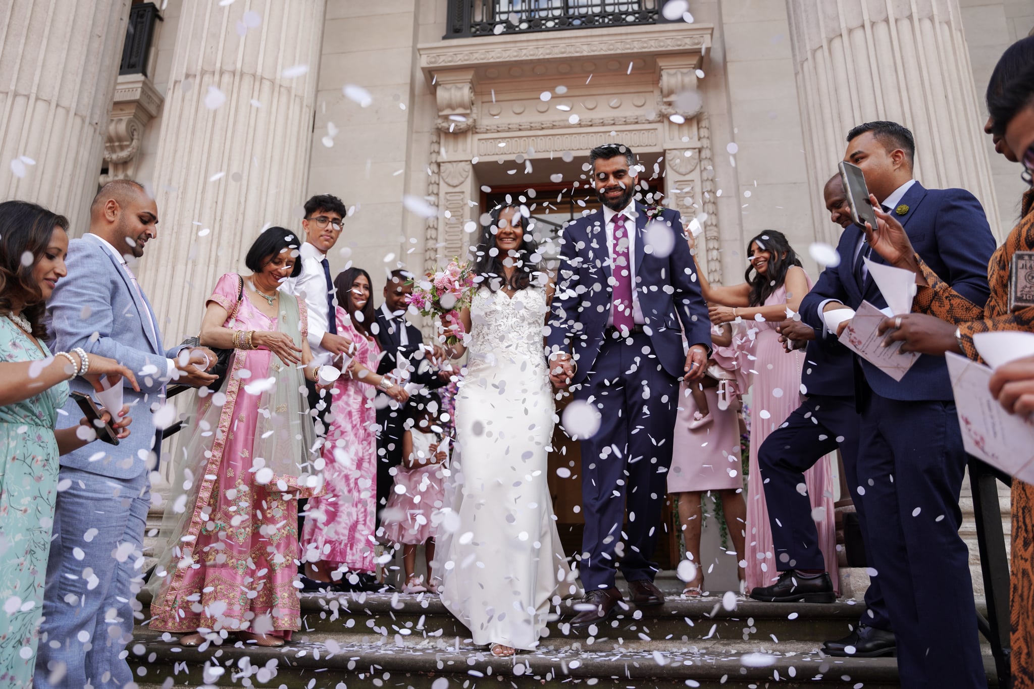 Marylebone Town Hall bride and groom under a shower of confetti