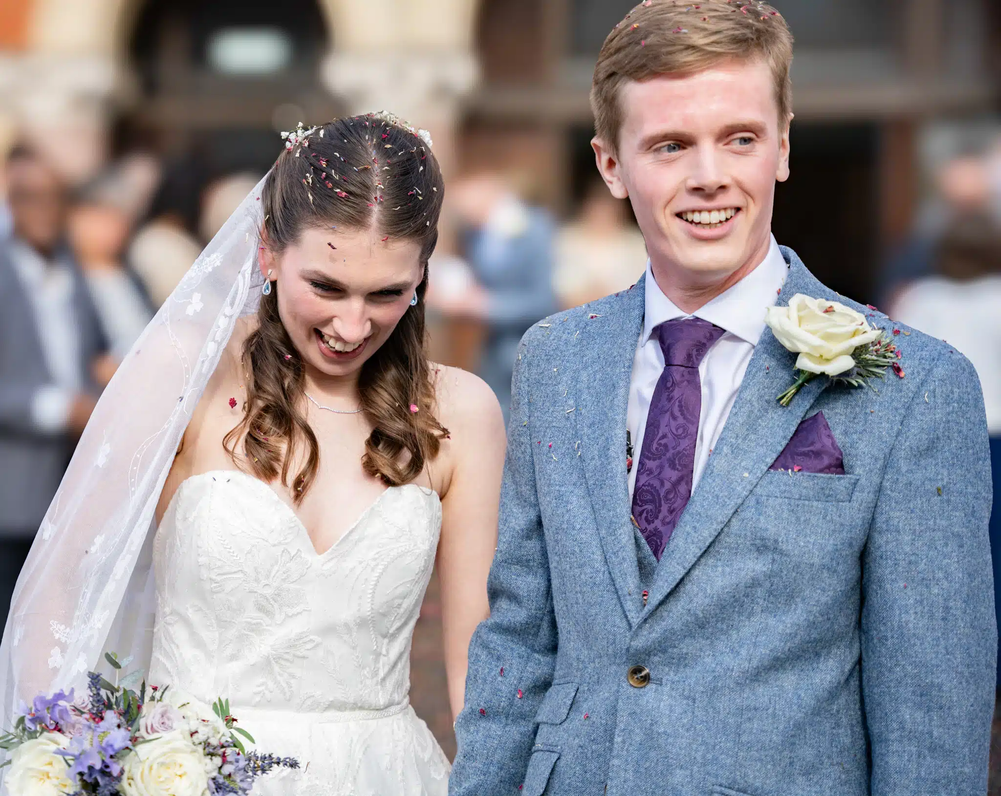 bride and groom under confetti
