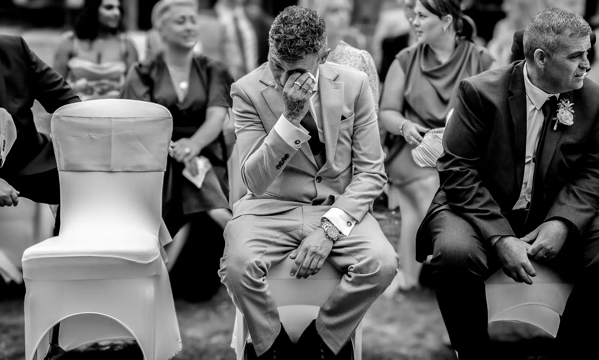man in suit crying at wedding black and white image
