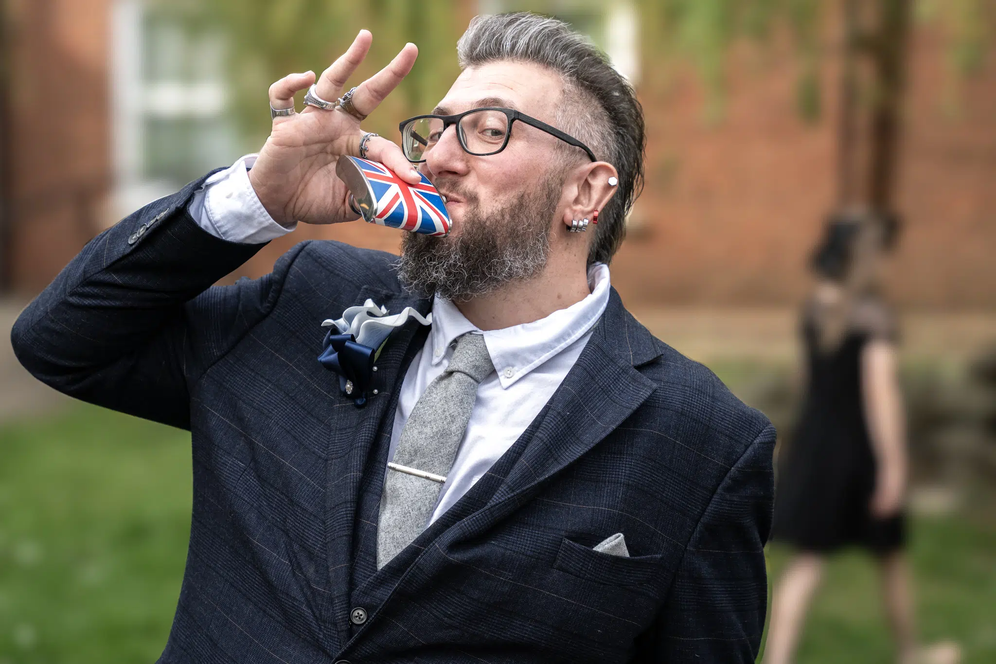 best man at wedding drinking from hip flask