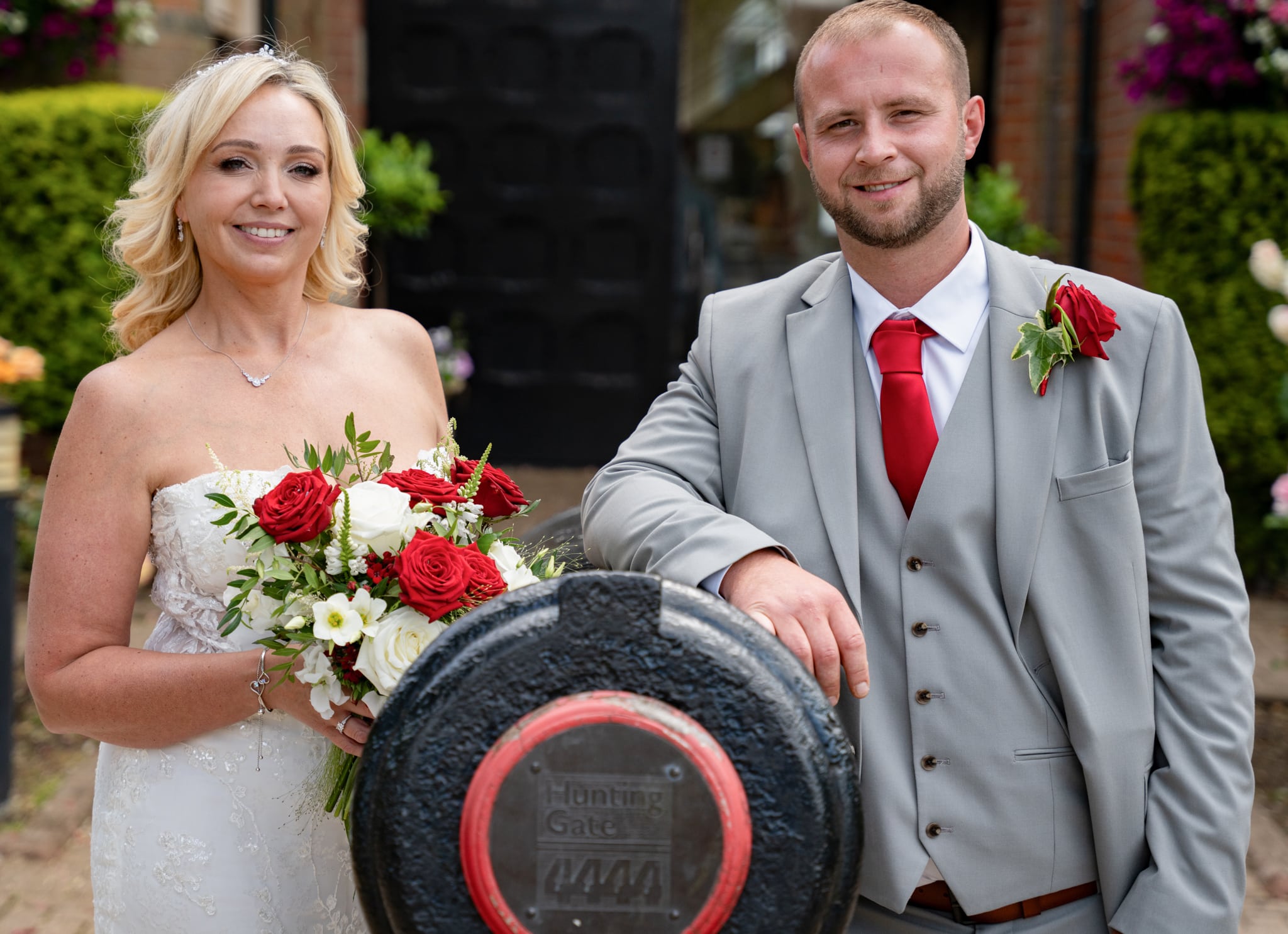 bride and groom stood smiling by cannon at st albans registry office