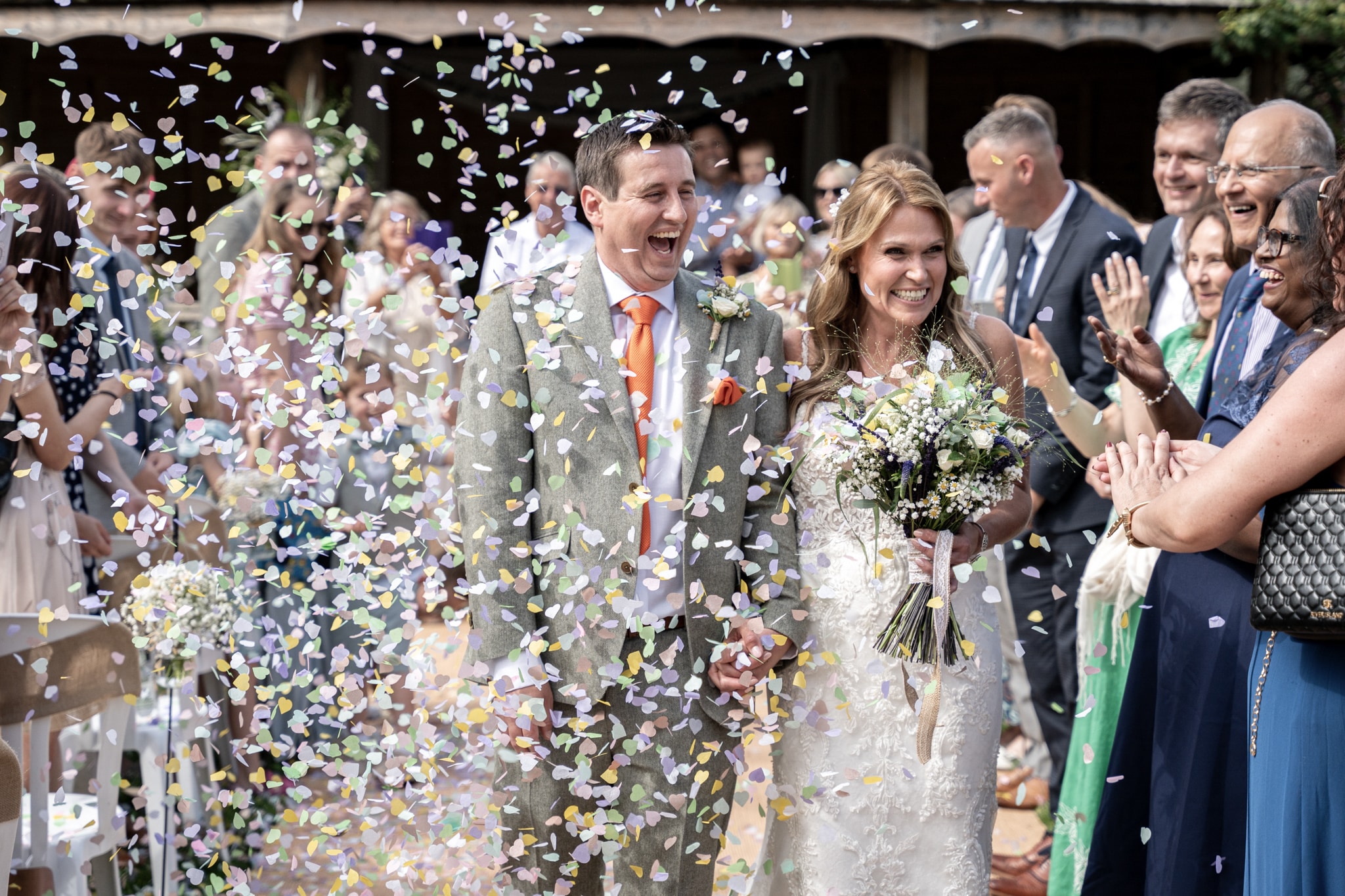 bride and groom getting showered with confetti