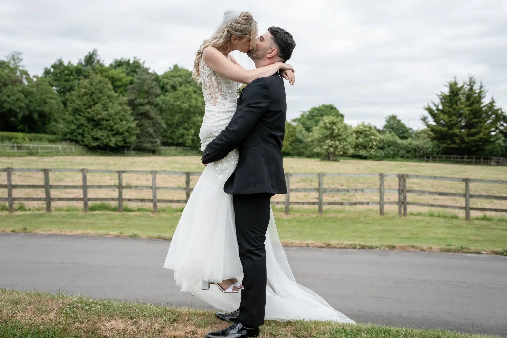 Bride and groom embracing and kissing at Tudor Barn Burnham