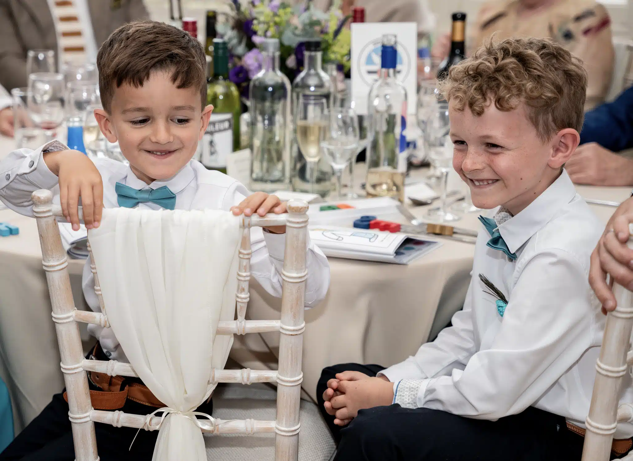 2 little boys laughing at wedding