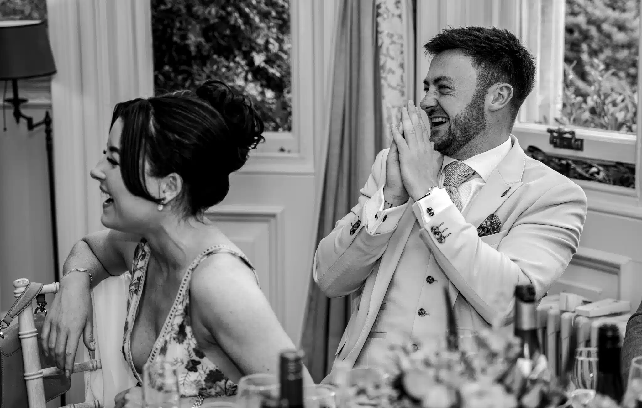 man laughing at wedding speeches 