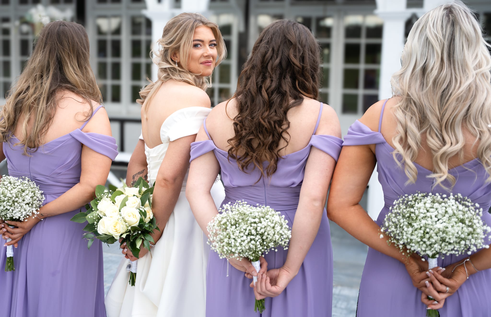 bide and bridesmaids in lavender dresses with white flowers
