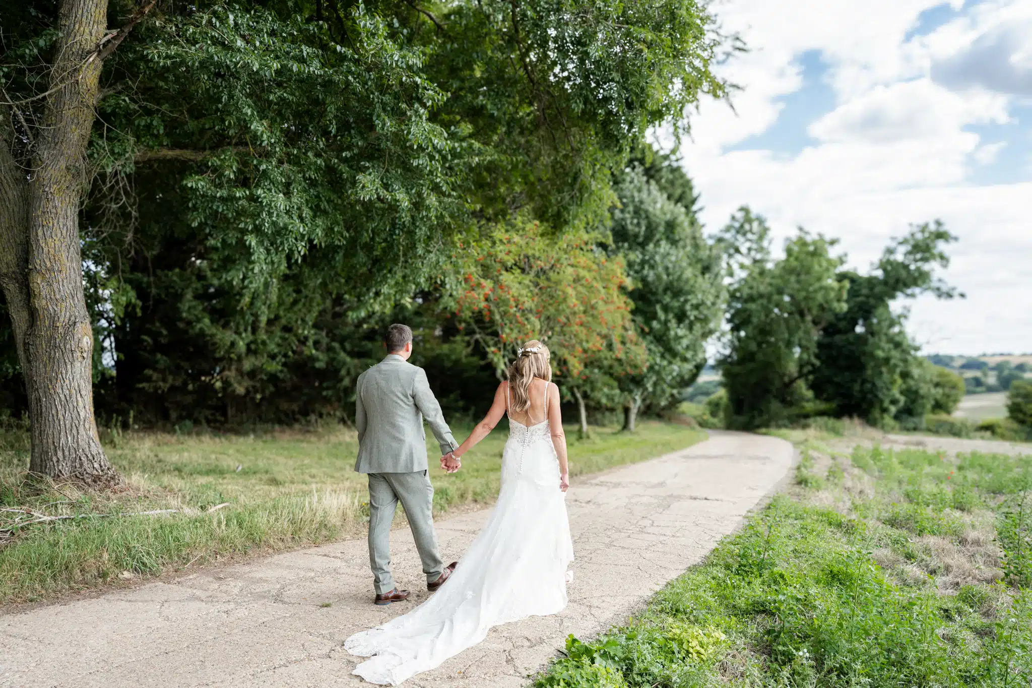 Bride and groom walking through Milton Keynes park – natural wedding photographer Milton Keynes