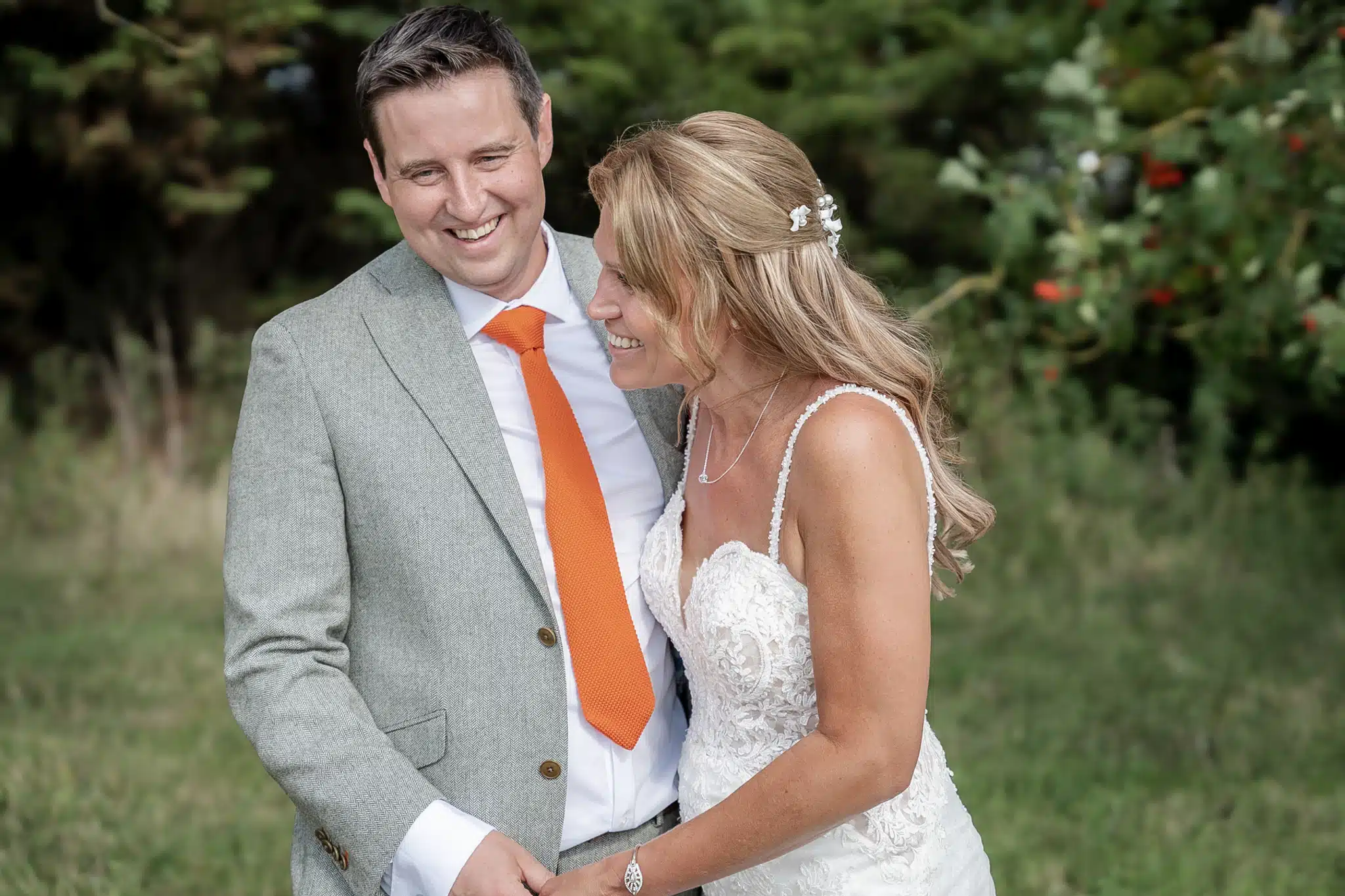 Bride and groom walking through Milton Keynes park – natural wedding photographer Milton Keynes