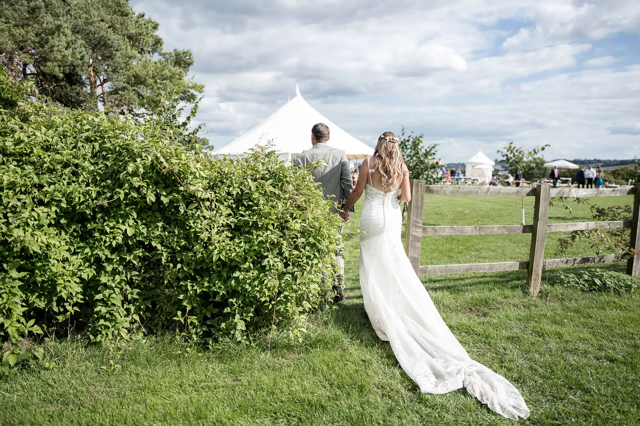 Bride and groom walking through Milton Keynes park – natural wedding photographer Milton Keynes