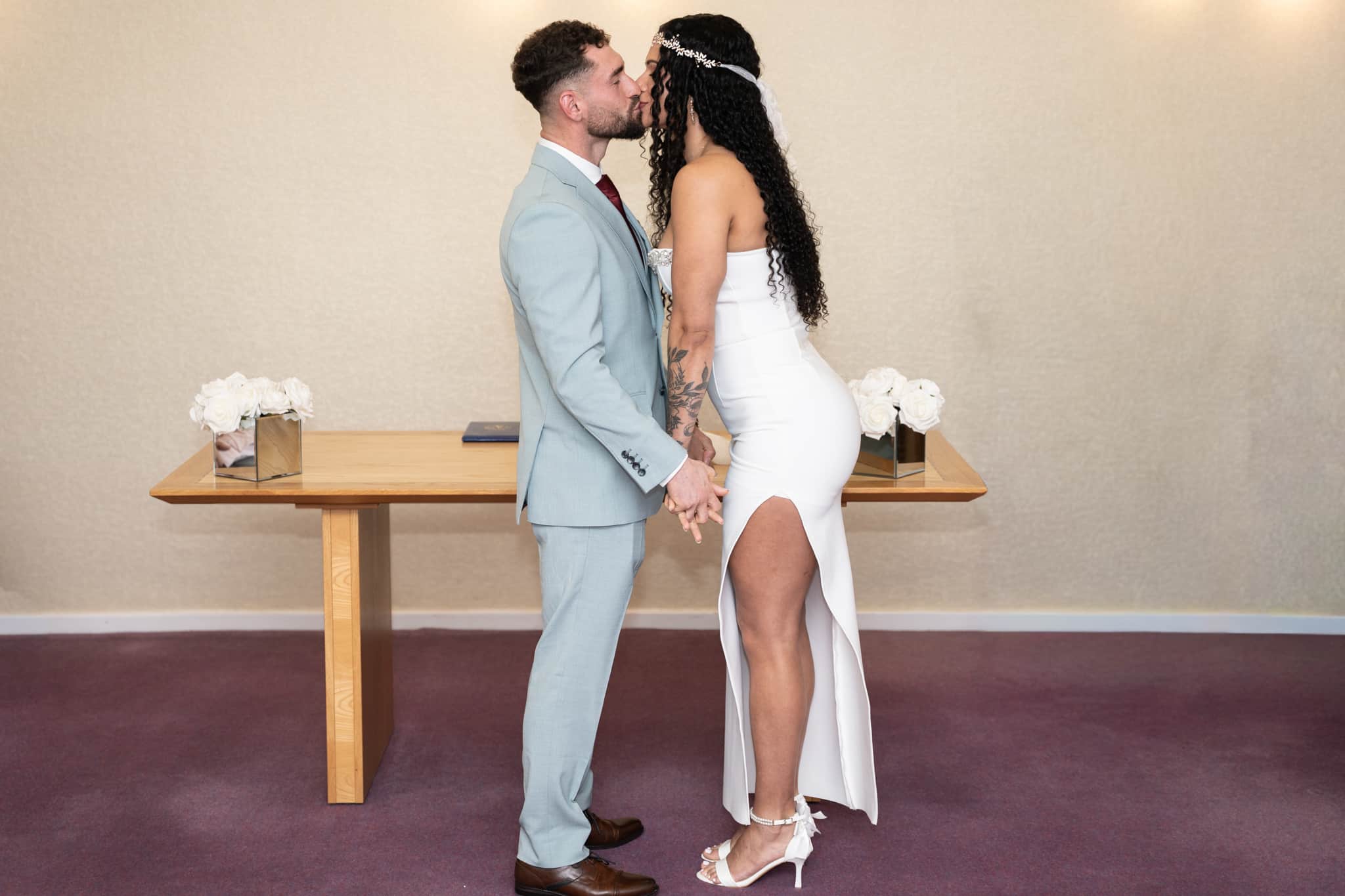 Bride and groom kissing at wedding ceremony