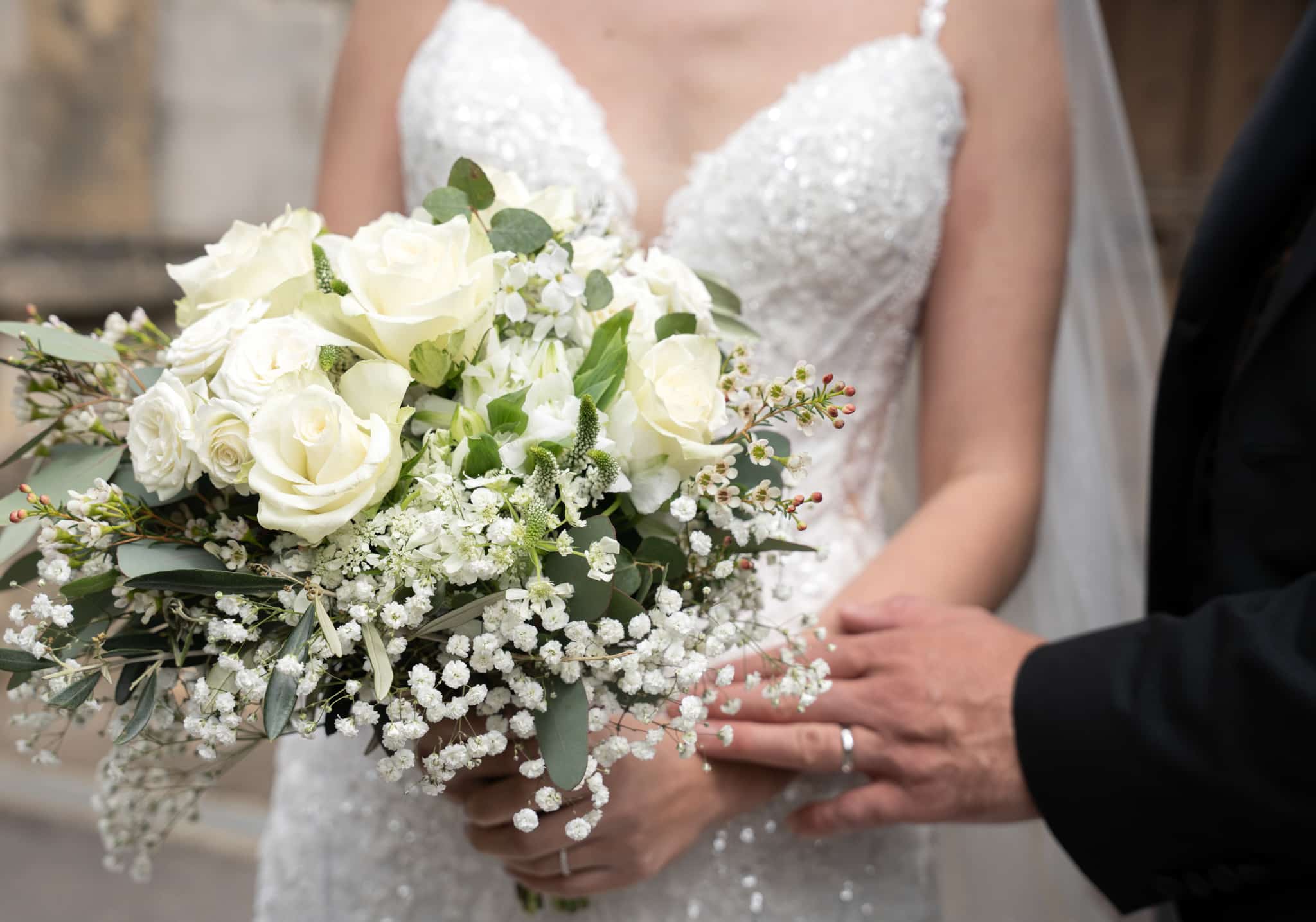 white bridal bouquet being held by bride