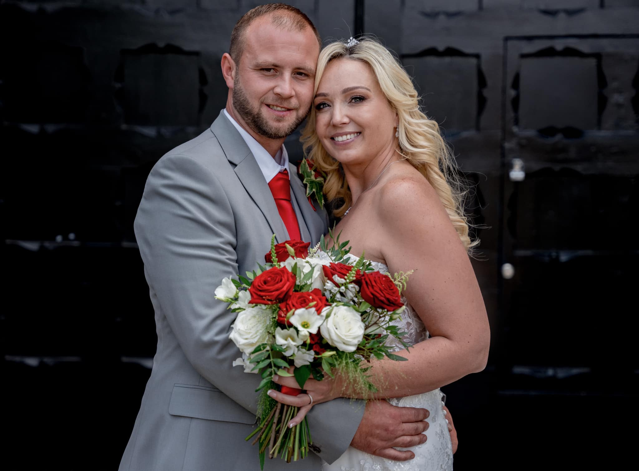bride and groom by the doors of st albans registry office