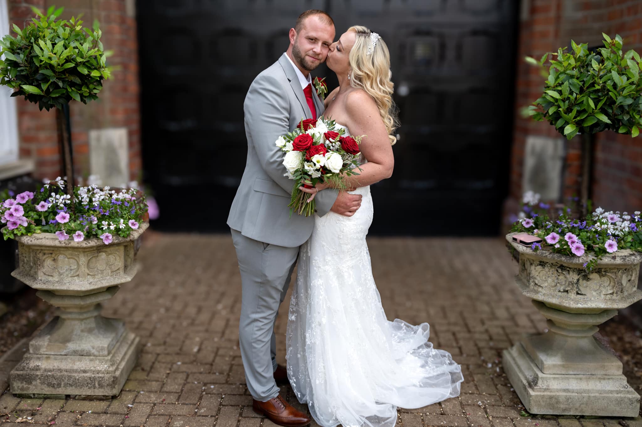 bride kissing grooms cheek at st albans registry office