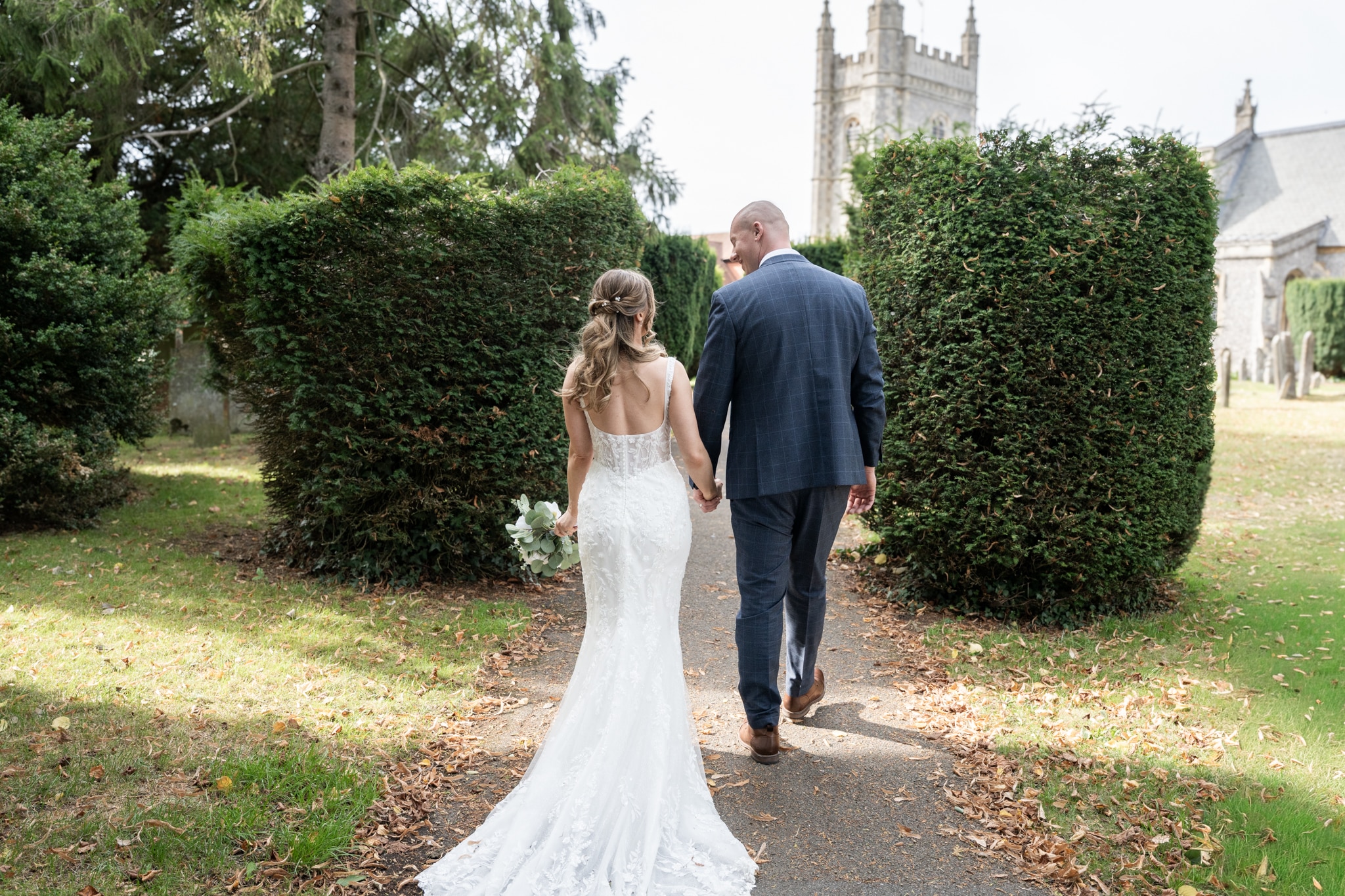 bride and groom holding hands near beaconsfield registry office