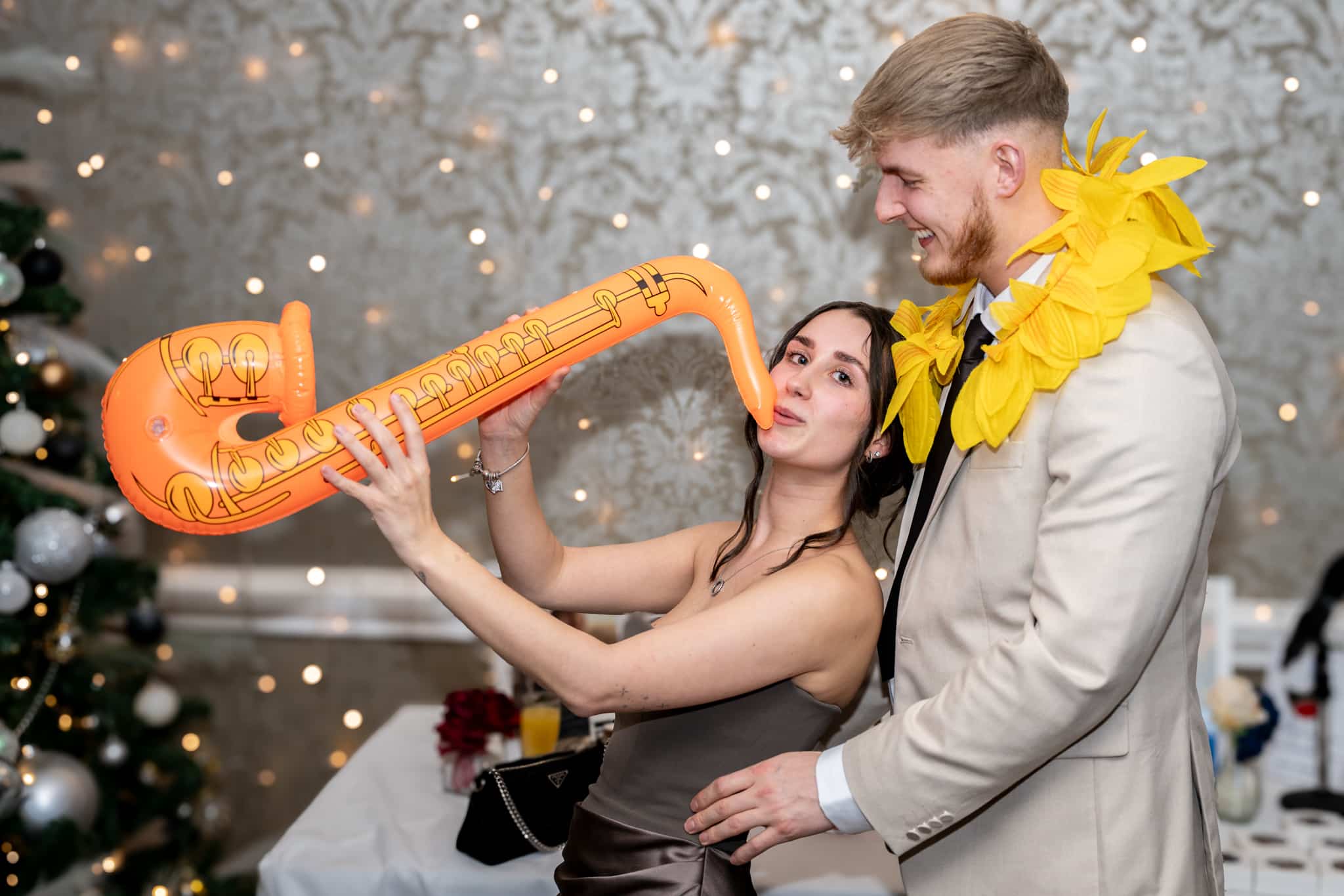 lady playing orange blow up saxophone