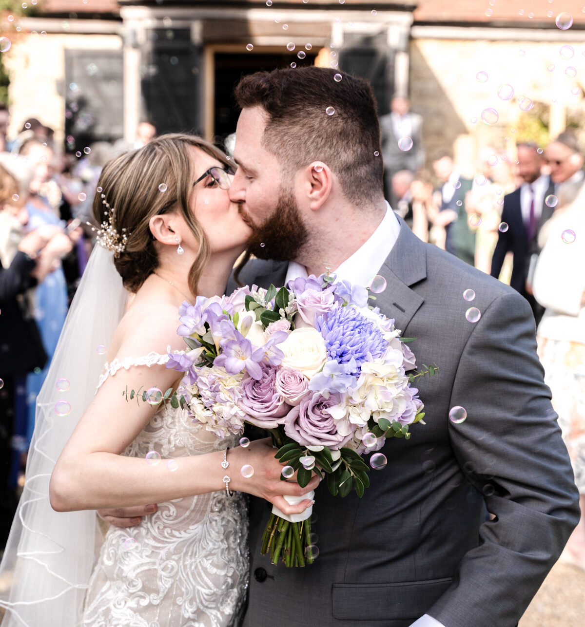 Bride and groom kissing at Notley Tythe barn