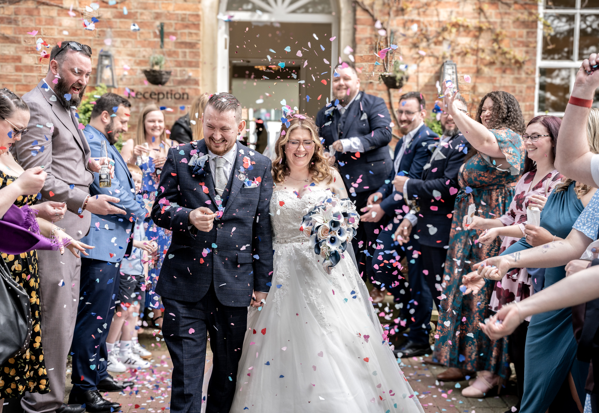 bride and groom under a shower of confetti