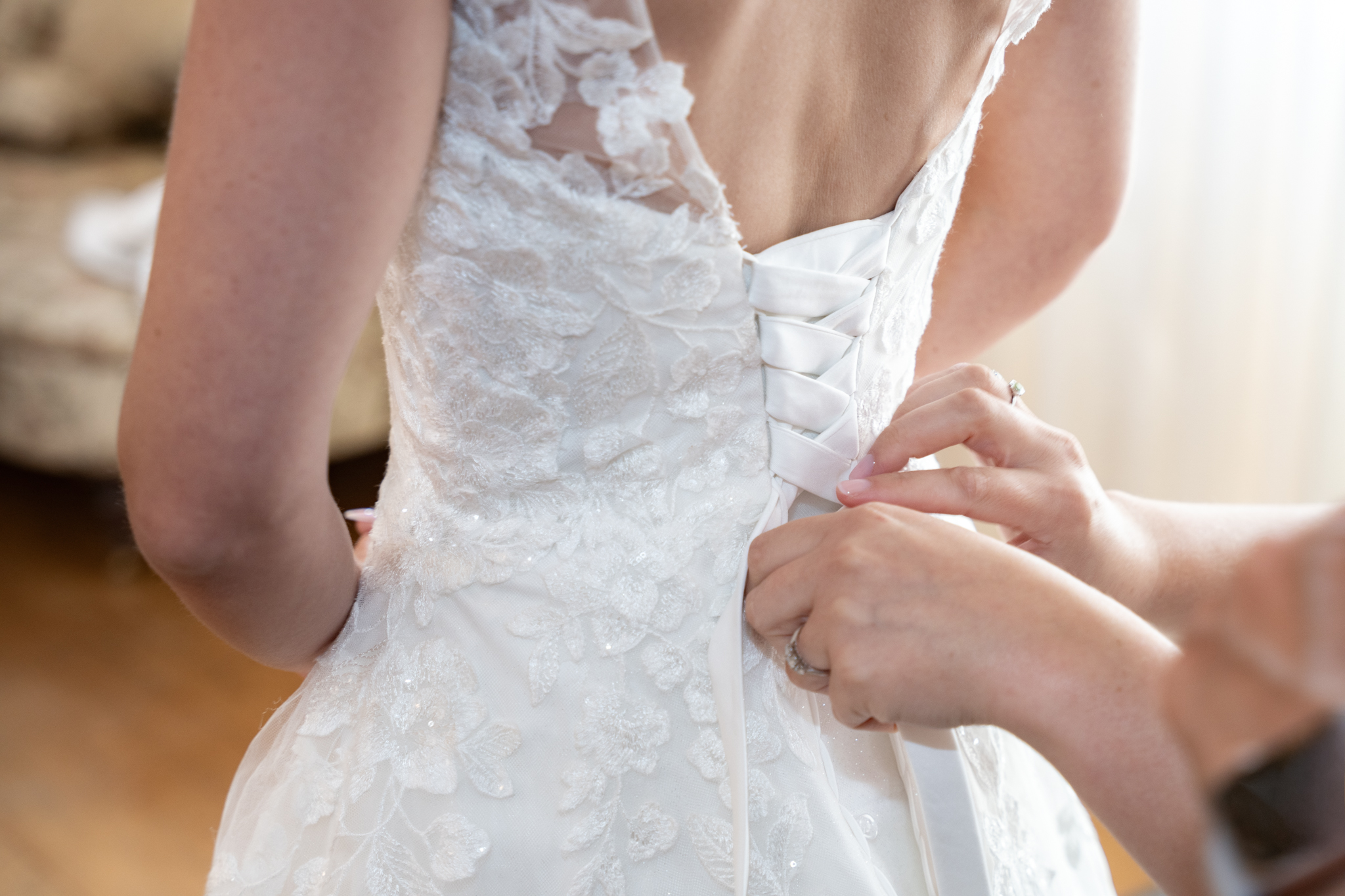 doing up brides dress at rackleys Barn