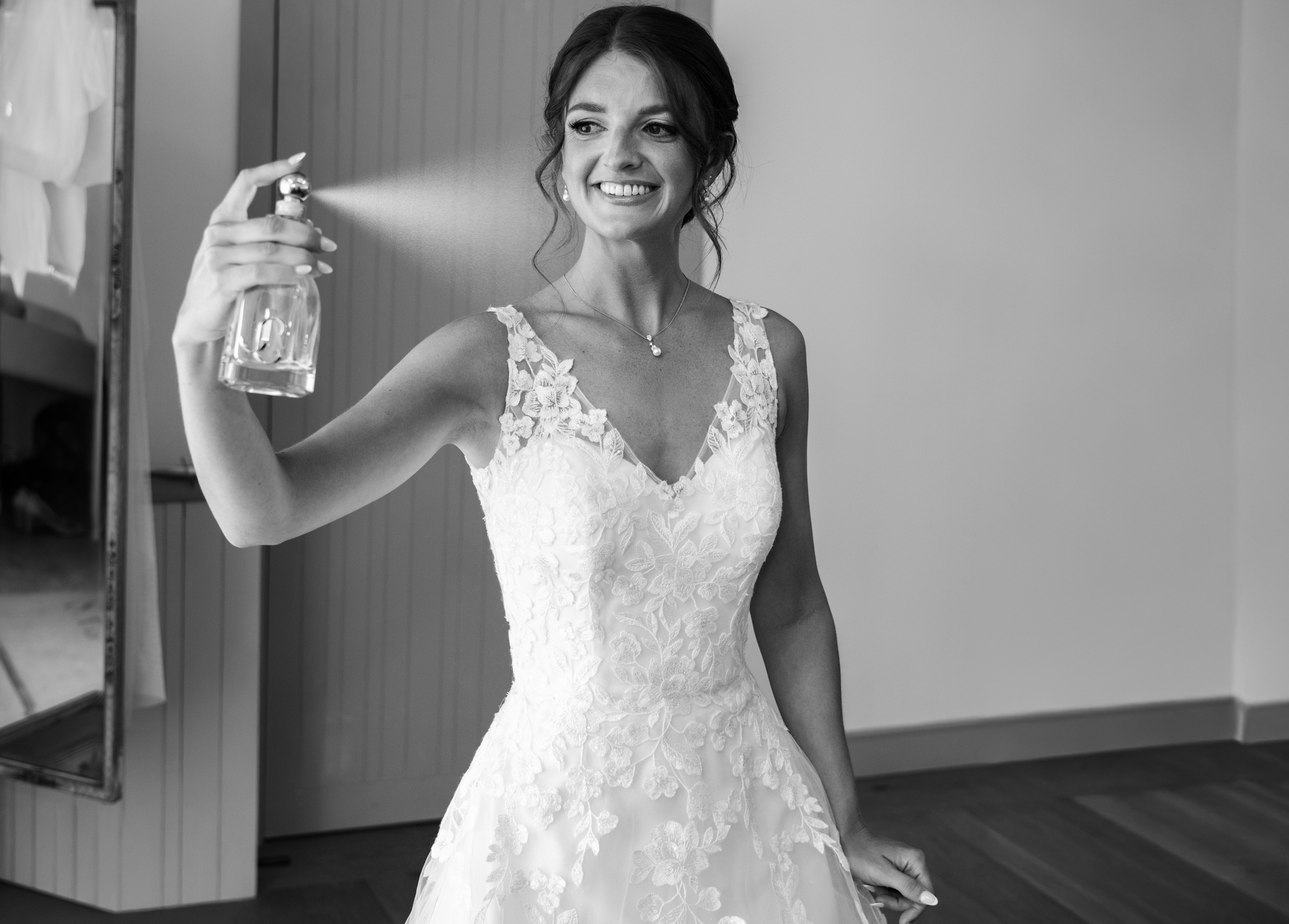 Bride spraying perfume at Rackleys Barn