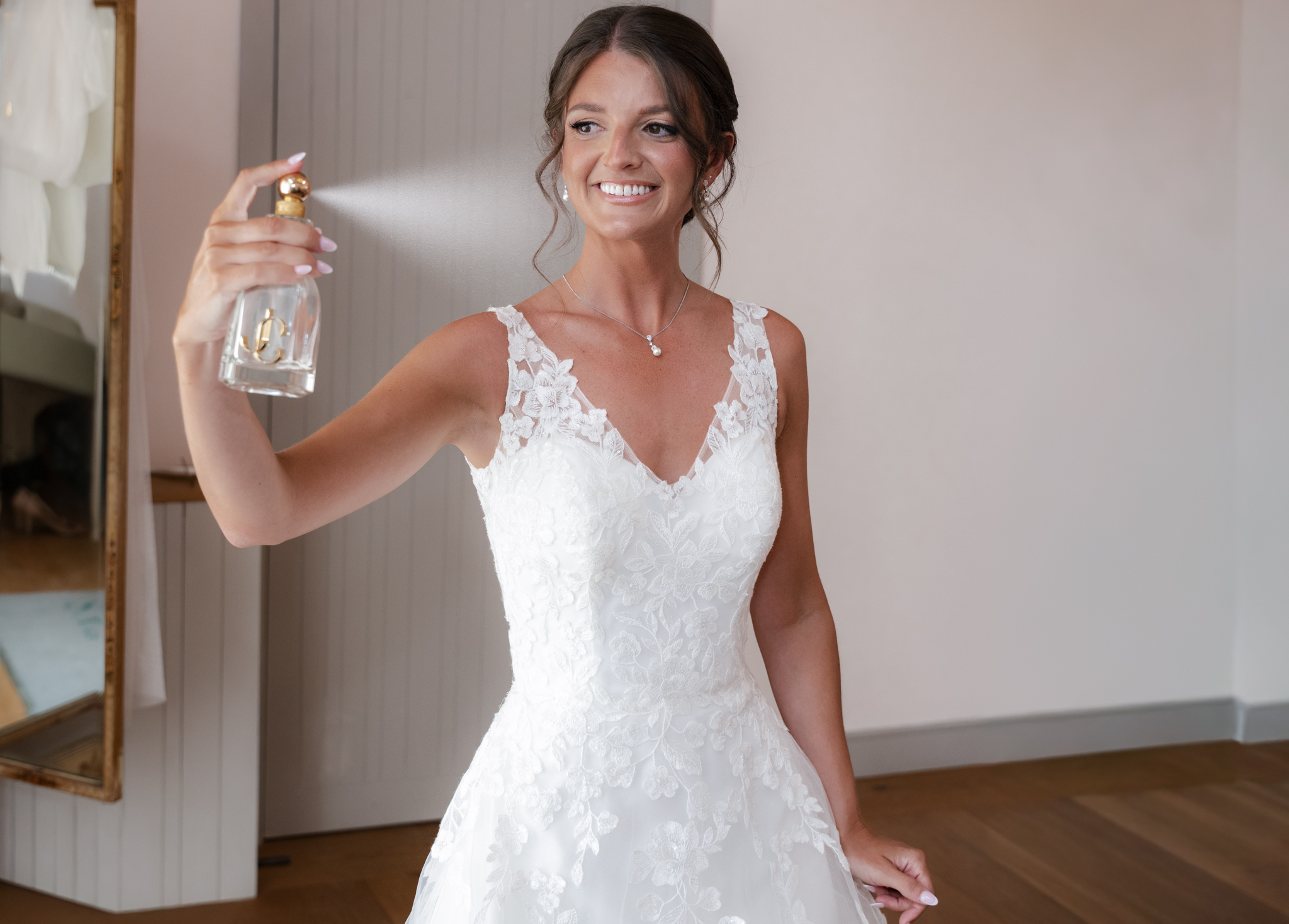 Bride spraying perfume