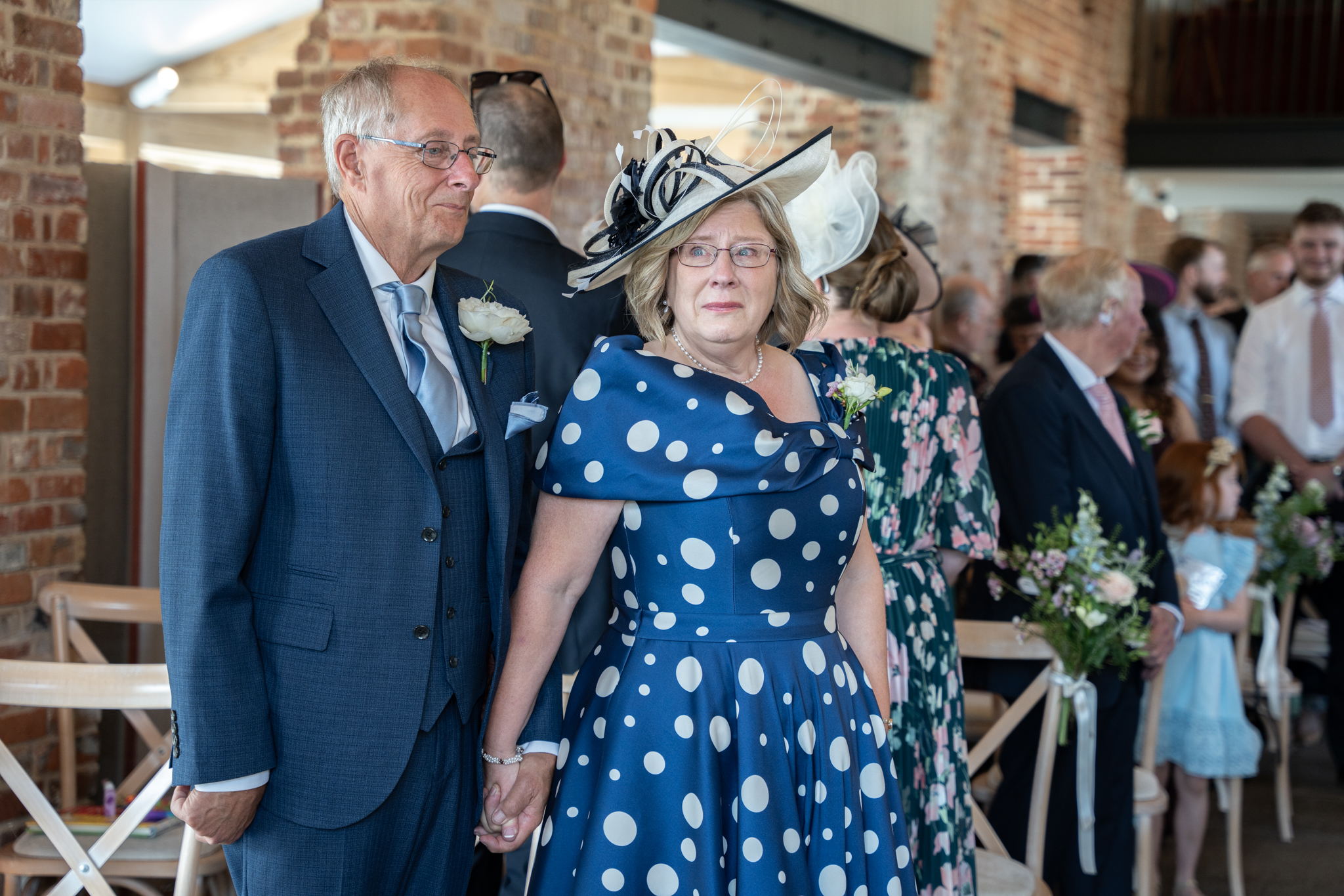 parents of the groom at wedding looking emotional