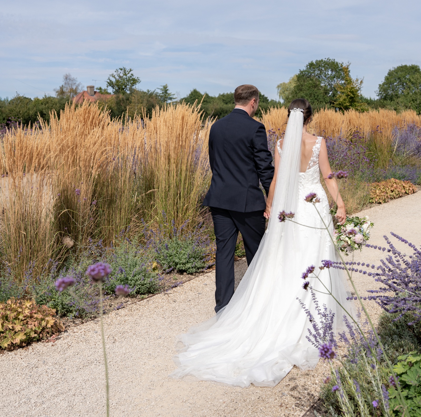 Bride and groom walking in the grounds of Rackleys Barn
