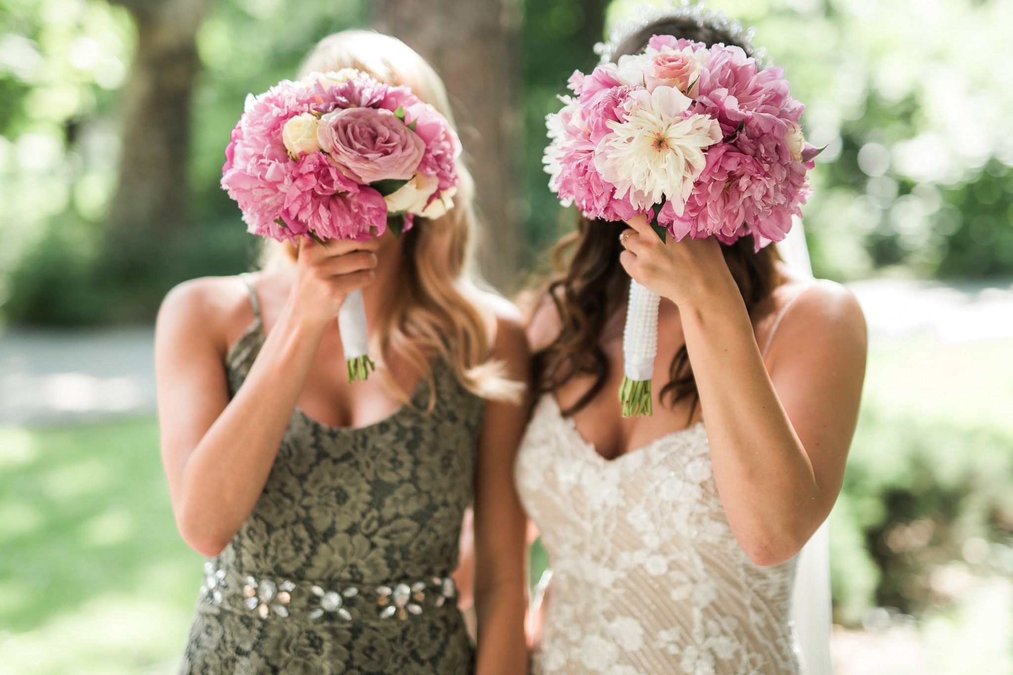 Bride and her bridesmaid with flower on their face